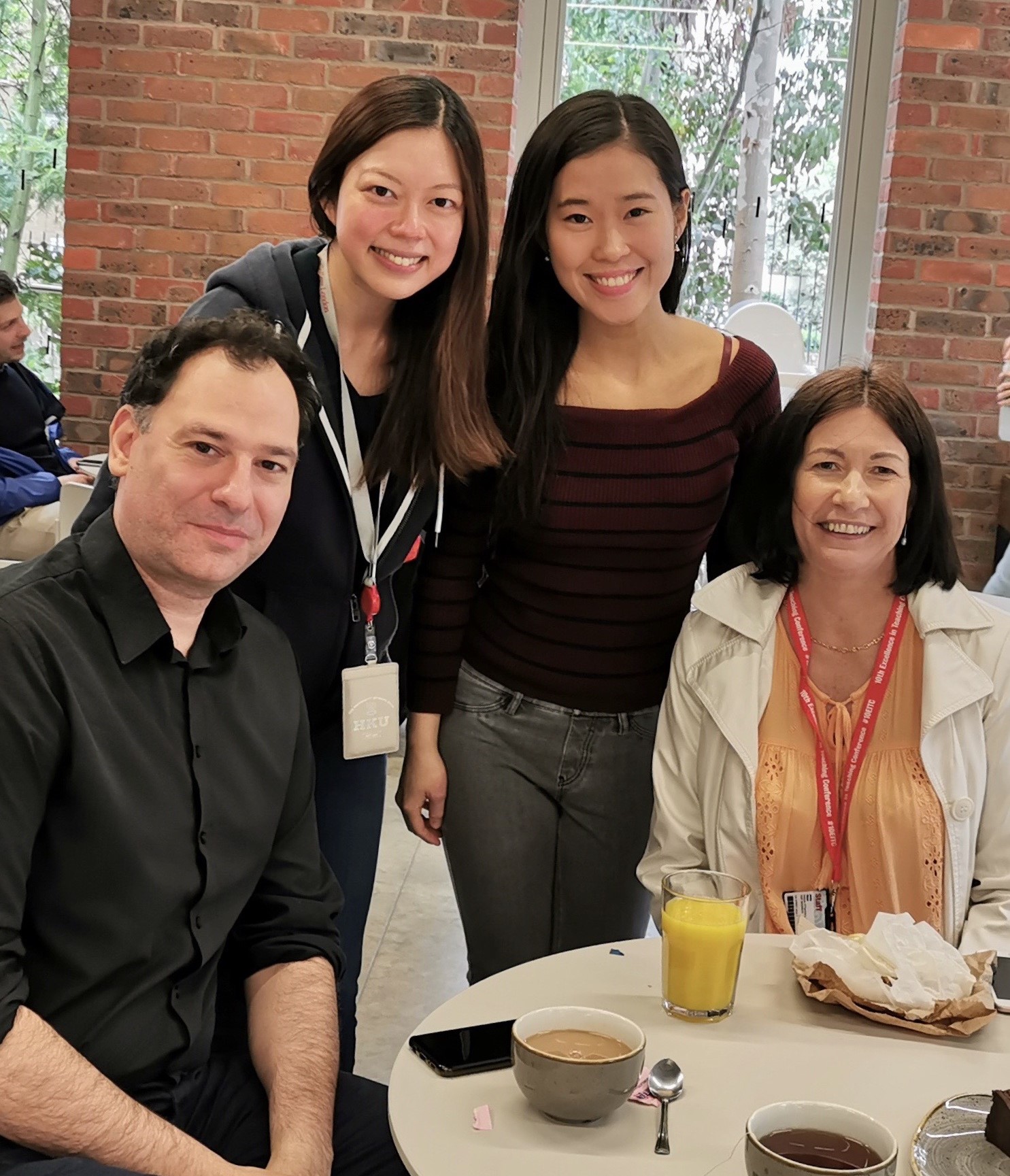 Dr. Lam (second from left) with Dr. Jenny Yiend (right), supervisor at KCL, and associates at KCL