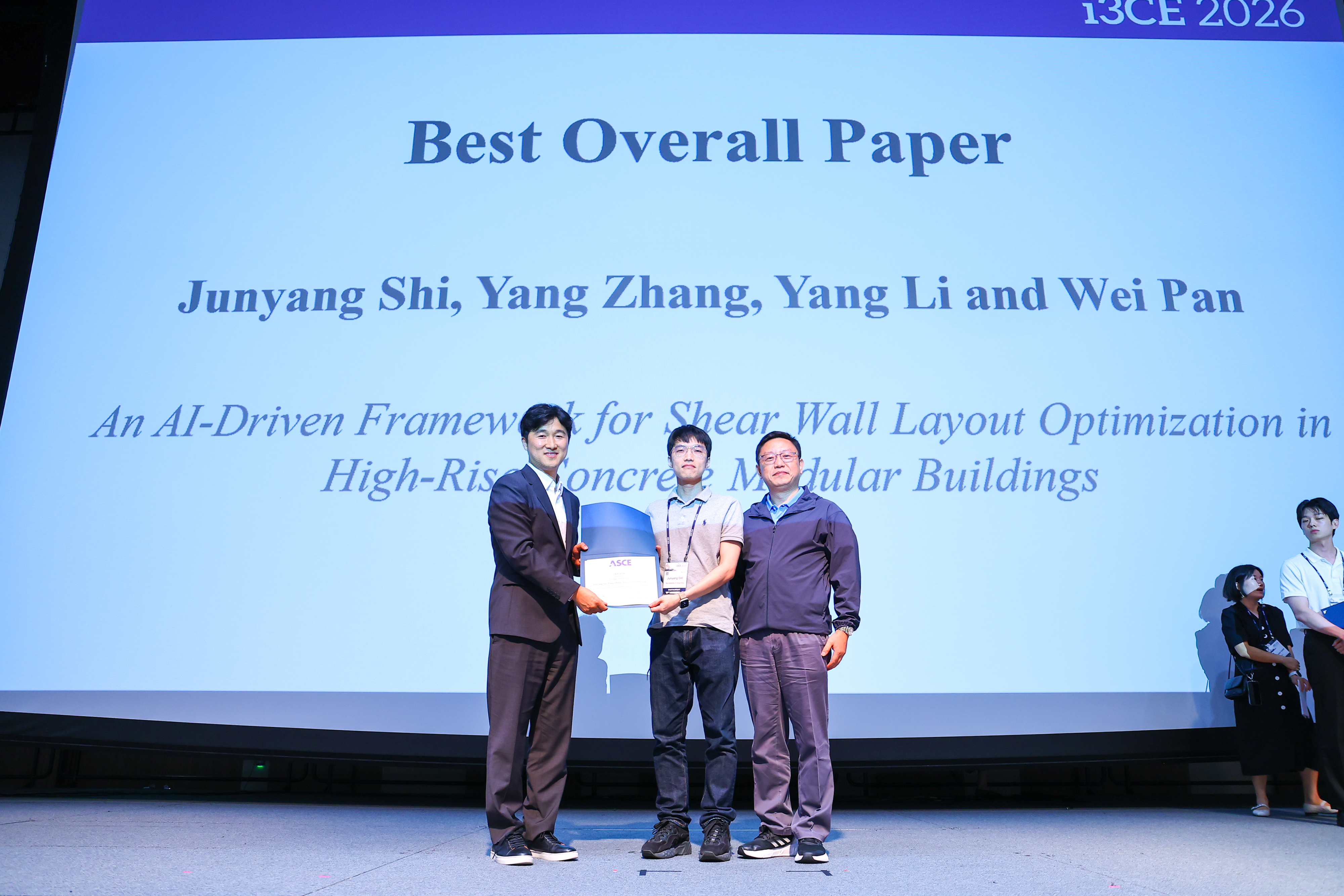 Junyang Shi (middle) and Professor Wei Pan (right) receiving the Best Overall Paper award at i3CE 2026.