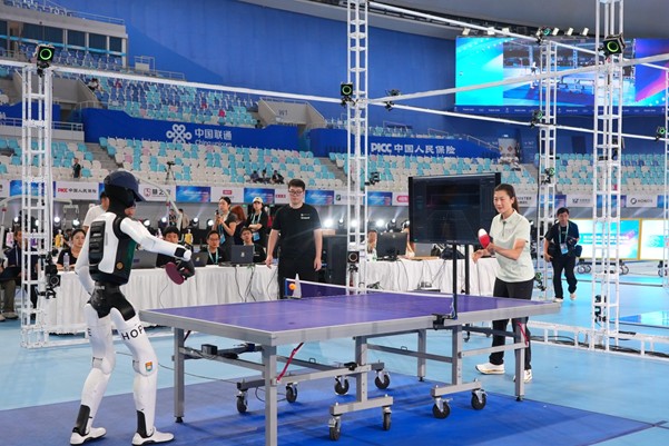 The team rallies with Olympic and World Table Tennis Champion Ning Ding during the opening ceremony of the Games.